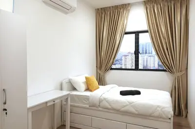 a bedroom with a bed and a desk and a window at Residensi Rampai 2 - lake view in setapak in Kuala Lumpur