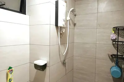 a bathroom with a shower with a phone in it at Residensi Rampai 2 - lake view in setapak in Kuala Lumpur