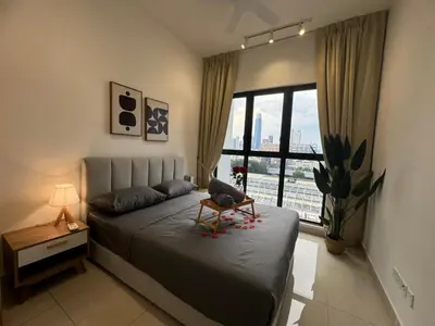 a bedroom with a bed with a chair on it at TRION 2, KLCC TRX IKEA at Chan Sow Lin, Kuala Lumpur by One Guesthouse in Kuala Lumpur