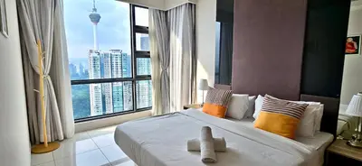 a bedroom with a large bed with a large window at Balcony Cityscape III The Robertson Residence 41f in Kuala Lumpur