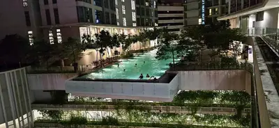 a large swimming pool in a city at night at Balcony Cityscape III The Robertson Residence 41f in Kuala Lumpur
