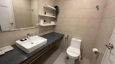 a white bathroom with a sink and a toilet at Balcony Cityscape III The Robertson Residence 41f in Kuala Lumpur