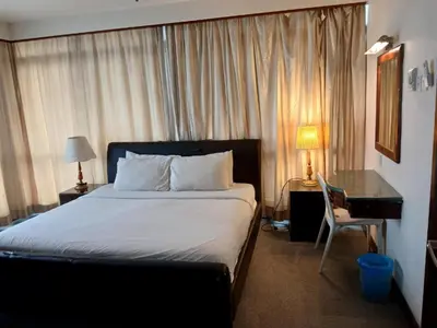 a bedroom with a bed with a desk and a bed sidx sidx sidx at Gorgeous service suite at Imbi in Kuala Lumpur