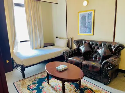 a living room with a couch and a bed at Gorgeous service suite at Imbi in Kuala Lumpur