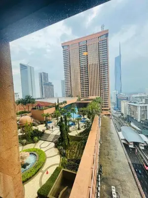 a view of a city with a tall building at Gorgeous service suite at Imbi in Kuala Lumpur
