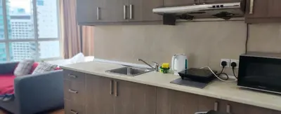 a kitchen counter with a sink and a microwave at Parkview KLCC ITSKAYA 21 NEW in Kuala Lumpur