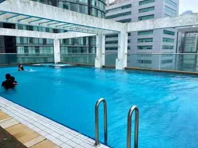 a large blue swimming pool in a building at Parkview KLCC ITSKAYA 21 NEW in Kuala Lumpur