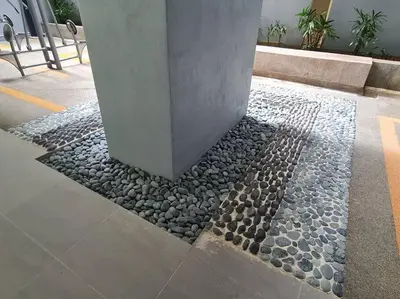 a stone walkway with a pillar in a building at Mini Studio Near Gleneagles 10 mins to KLCC in Kuala Lumpur