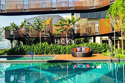 a swimming pool in front of a building with a bridge at KL City View at Trion 2 by HCK in Kuala Lumpur