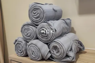 a pile of towels stacked on a table at KL City View at Trion 2 by HCK in Kuala Lumpur