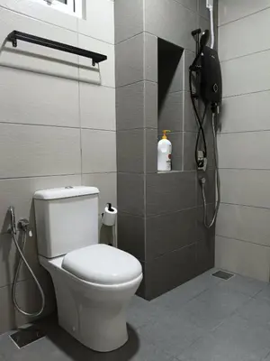 a bathroom with a toilet and a shower with a phone at 2BR Centre MontKiara 4px 500Mbps in Kuala Lumpur