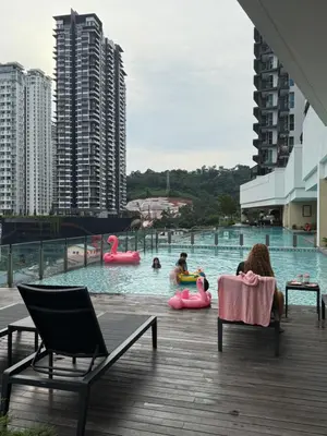 a group of people in a swimming pool with pink flamingos at 2BR Centre MontKiara 4px 500Mbps in Kuala Lumpur