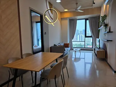 a dining room with a wooden table and chairs at Opus Residences by Star Haven in Kuala Lumpur