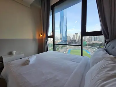 a bedroom with a white bed and a large window at Opus Residences by Star Haven in Kuala Lumpur