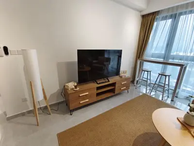 a living room with a flat screen tv on a dresser at Agile Bukit Bintang KLCC in Kuala Lumpur