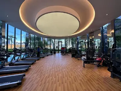 a gym with rows of tread machines and a large ceiling at Trion SFM Dream Service suit in Kuala Lumpur