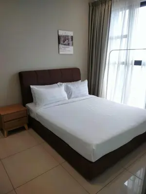 a bed in a room with a large window at Trion SFM Dream Service suit in Kuala Lumpur