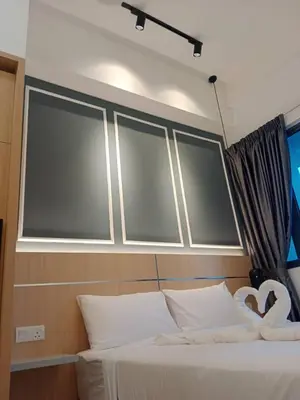 a bedroom with a bed with three windows above it at The Luxe KLCC by NZ in Kuala Lumpur
