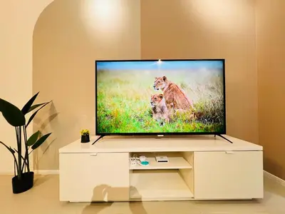 a flat screen tv sitting on a white entertainment center at Arcoris Residence Mont Kiara by DeUrban in Kuala Lumpur