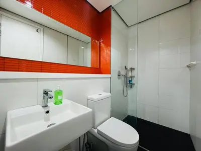 a bathroom with a white toilet and a sink at Arcoris Residence Mont Kiara by DeUrban in Kuala Lumpur