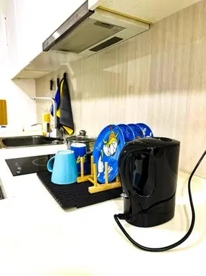 a kitchen counter with a backpack and a sink at Nordic Europe Style in Kuala Lumpur
