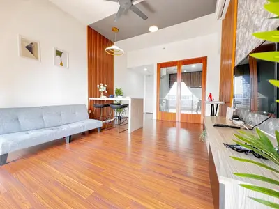 a living room with a couch and a table at Una Serviced Apartment by Manhattan Group in Kuala Lumpur