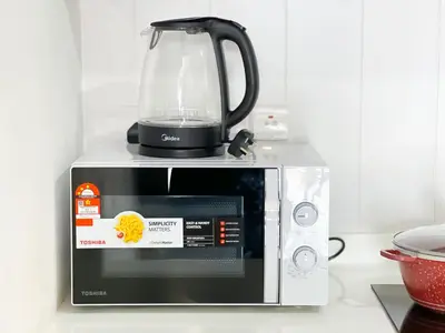a blender sitting on top of a microwave at Una Serviced Apartment by Manhattan Group in Kuala Lumpur