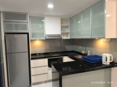 a kitchen with white cabinets and a black counter top at 0203 Sweet Home-Casa Residency 2R 2B City View in Kuala Lumpur
