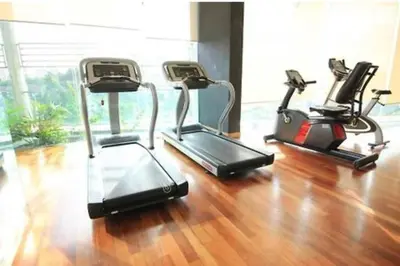 three exercise bikes in a gym with a wooden floor at 0203s Sweet Home-Casa Residency in Kuala Lumpur