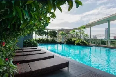 a swimming pool with benches in a building at 0203s Sweet Home-Casa Residency in Kuala Lumpur
