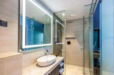a bathroom with a sink and a glass shower at Star Luxury By Star Residences KLCC in Kuala Lumpur