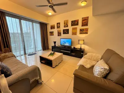 a living room with two couches and a flat screen tv at 8 KLCC 5 minutes to Jalan Alor Street Bukit Bintang Pavilion 10 Pax 3R2B in Kuala Lumpur