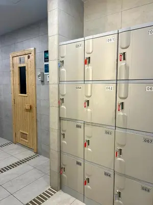 a row of lockers in a room with a door at KL Central 31st floor KLCC view in Kuala Lumpur