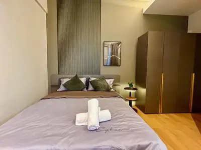 a bedroom with a bed with towels on it at KL Central 31st floor KLCC view in Kuala Lumpur