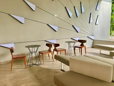 a room with chairs and tables and a wall with mirrors at KL Central 33rd Floor KLCC view in Kuala Lumpur