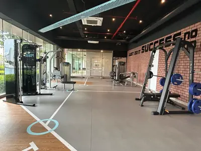 a gym with cardio equipment in a brick wall at KL Central 33rd Floor KLCC view in Kuala Lumpur