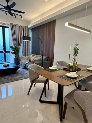 a dining room and living room with a table and chairs at KL Central 33rd Floor KLCC view in Kuala Lumpur