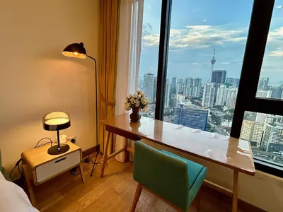 a room with a desk and a window with a view at Studio with Amazing KLCC View & Infinity Pool at Lalaport Bukit Bintang in Kuala Lumpur