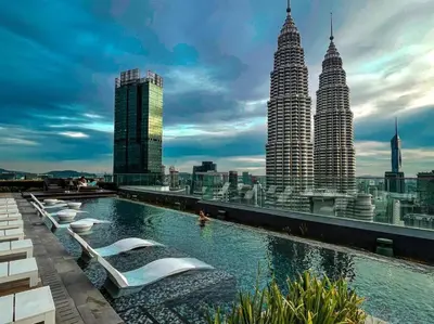 a pool on the roof of a building with tall buildings at Star Xtian Residence KLCC in Kuala Lumpur