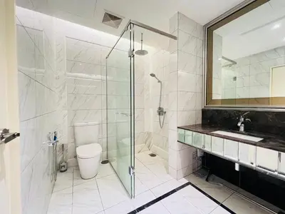 a bathroom with a shower and a toilet and a sink at Dorsett Sri Hartamas by DeUrban in Kuala Lumpur