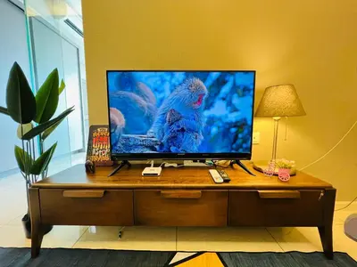 a tv sitting on top of a wooden table at Dorsett Sri Hartamas by DeUrban in Kuala Lumpur