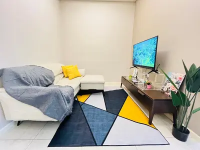 a living room with a couch and a table at Dorsett Sri Hartamas by DeUrban in Kuala Lumpur