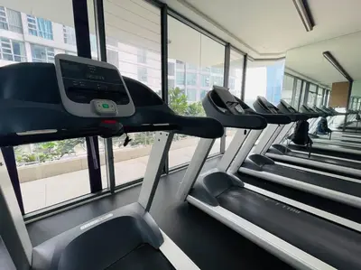 a gym with rows of treadmills in a building at The Robertson Bukit Bintang by DeUrban in Kuala Lumpur