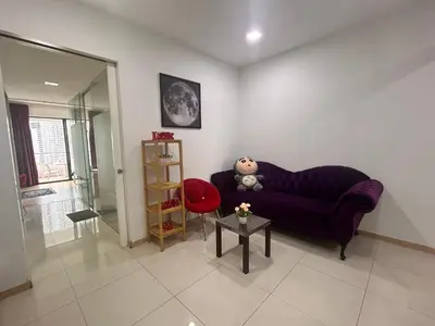 a living room with a purple couch and a red chair at Private Cinema and Jacuzzi at Pertama Residency in Kuala Lumpur