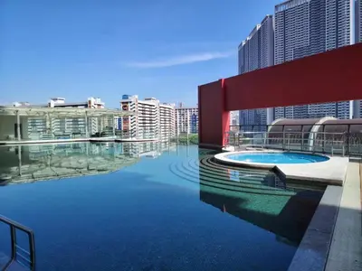 a pool in the middle of a city with tall buildings at Private Cinema and Jacuzzi at Pertama Residency in Kuala Lumpur