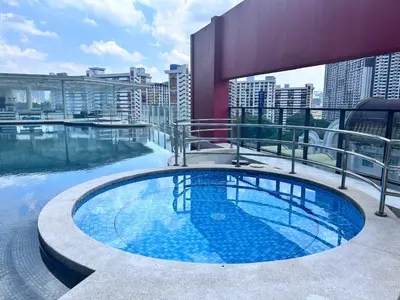 a swimming pool on the roof of a building at Private Cinema and Jacuzzi at Pertama Residency in Kuala Lumpur