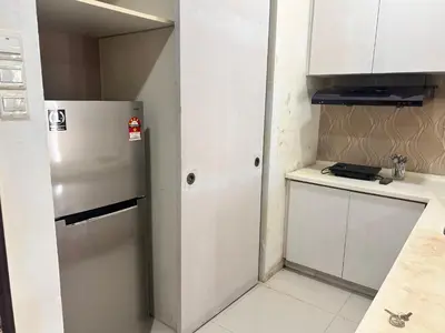 a small kitchen with a refrigerator and a counter at Private Cinema and Jacuzzi at Pertama Residency in Kuala Lumpur