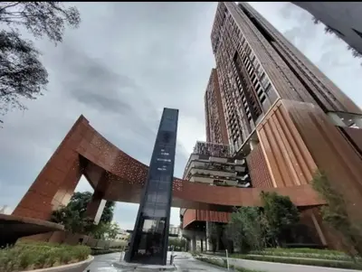 a tall building with a statue in front of it at Lucentia Residence Bukit Bintang by Ideal Homes in Kuala Lumpur