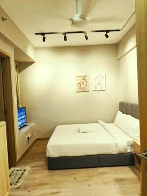 a small bedroom with a bed and a tv at The Luxe Colony KLCC BY Infinitum in Kuala Lumpur