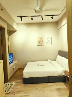 a small bedroom with a bed and a tv at The Luxe Colony KLCC BY Infinitum in Kuala Lumpur